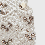 JONES + CO Mini Web Bag in silver featuring intricate macrame leather weaving and metallic bamboo bead details.