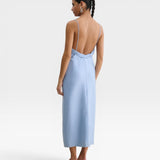 JONES + CO sky blue Manon wool midi dress with slim straps, draped neckline, and a striking low-cut back view.