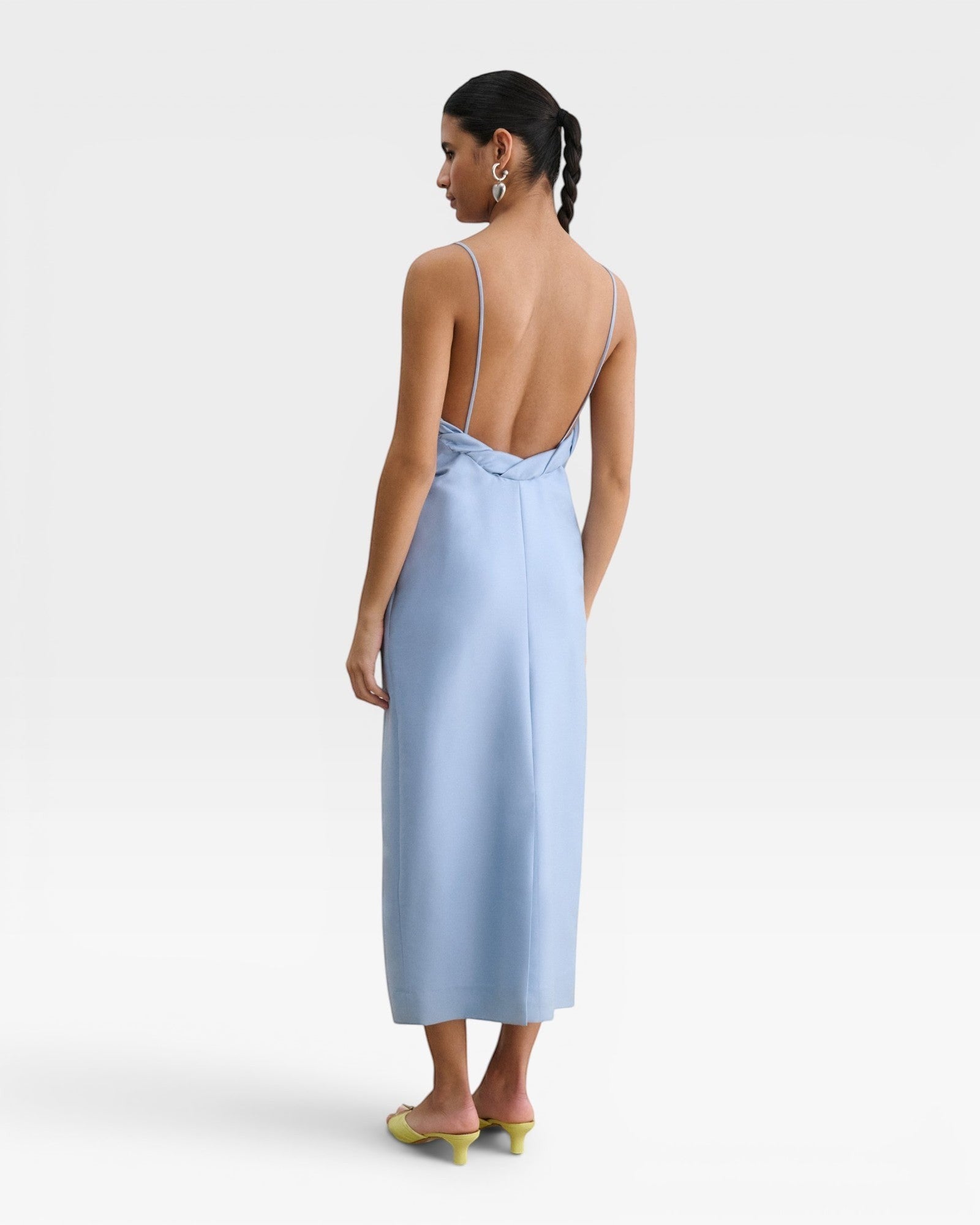 JONES + CO sky blue Manon wool midi dress with slim straps, draped neckline, and a striking low-cut back view.