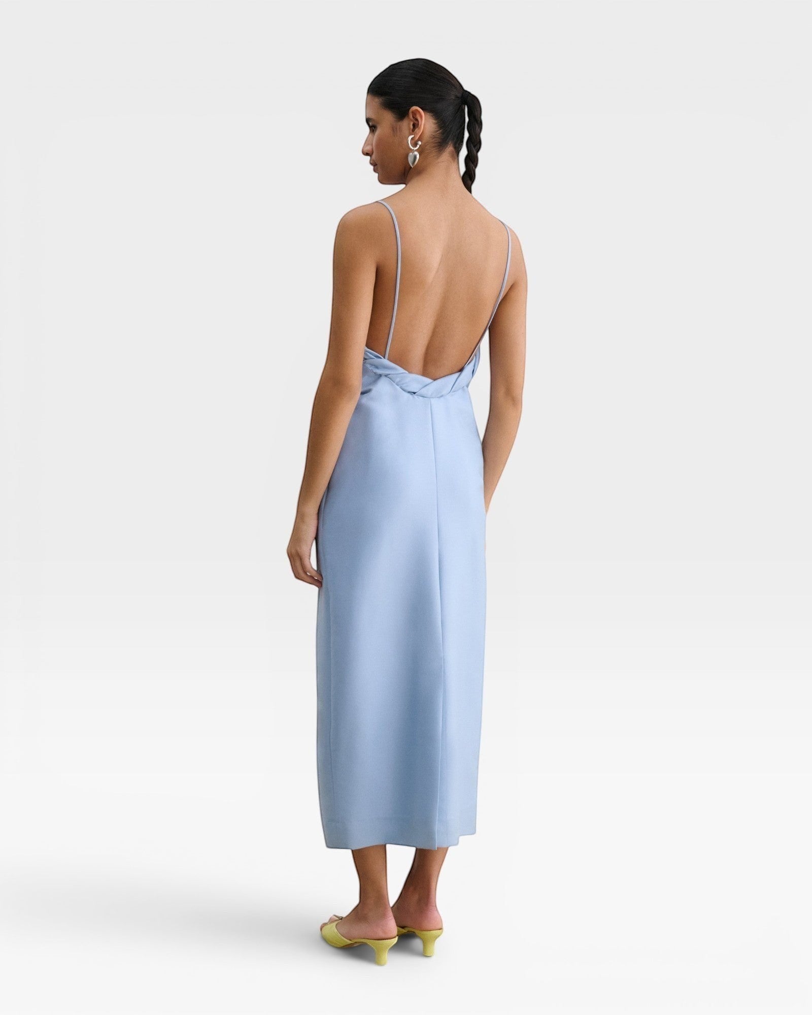 JONES + CO sky blue Manon wool midi dress with slim straps, draped neckline, and a striking low-cut back view.