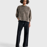 Model wearing a JONES + CO smoky hazelnut acid-overdyed cropped sweatshirt with raw-edge hem and dropped shoulders.