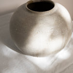 JONES + CO handthrown ceramic vase with a speckled off-white finish and rounded sculptural shape