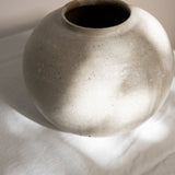 JONES + CO handthrown ceramic vase with a speckled off-white finish and rounded sculptural shape