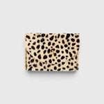 JONES + CO cardholder in beige and black spotted cowhide leather with a gold button closure.