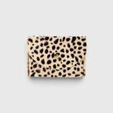 JONES + CO cardholder in beige and black spotted cowhide leather with a gold button closure.