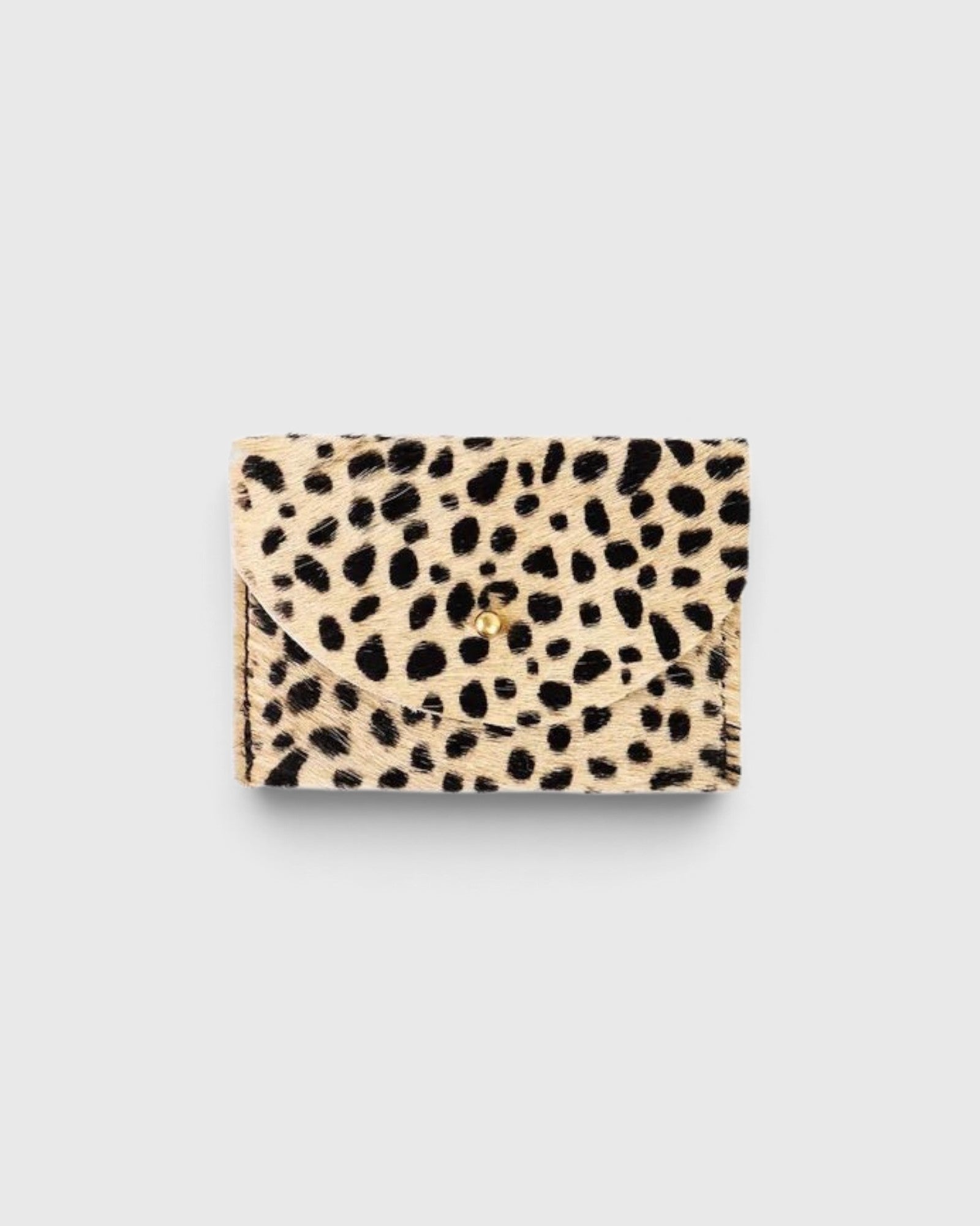 JONES + CO cardholder in beige and black spotted cowhide leather with a gold button closure.