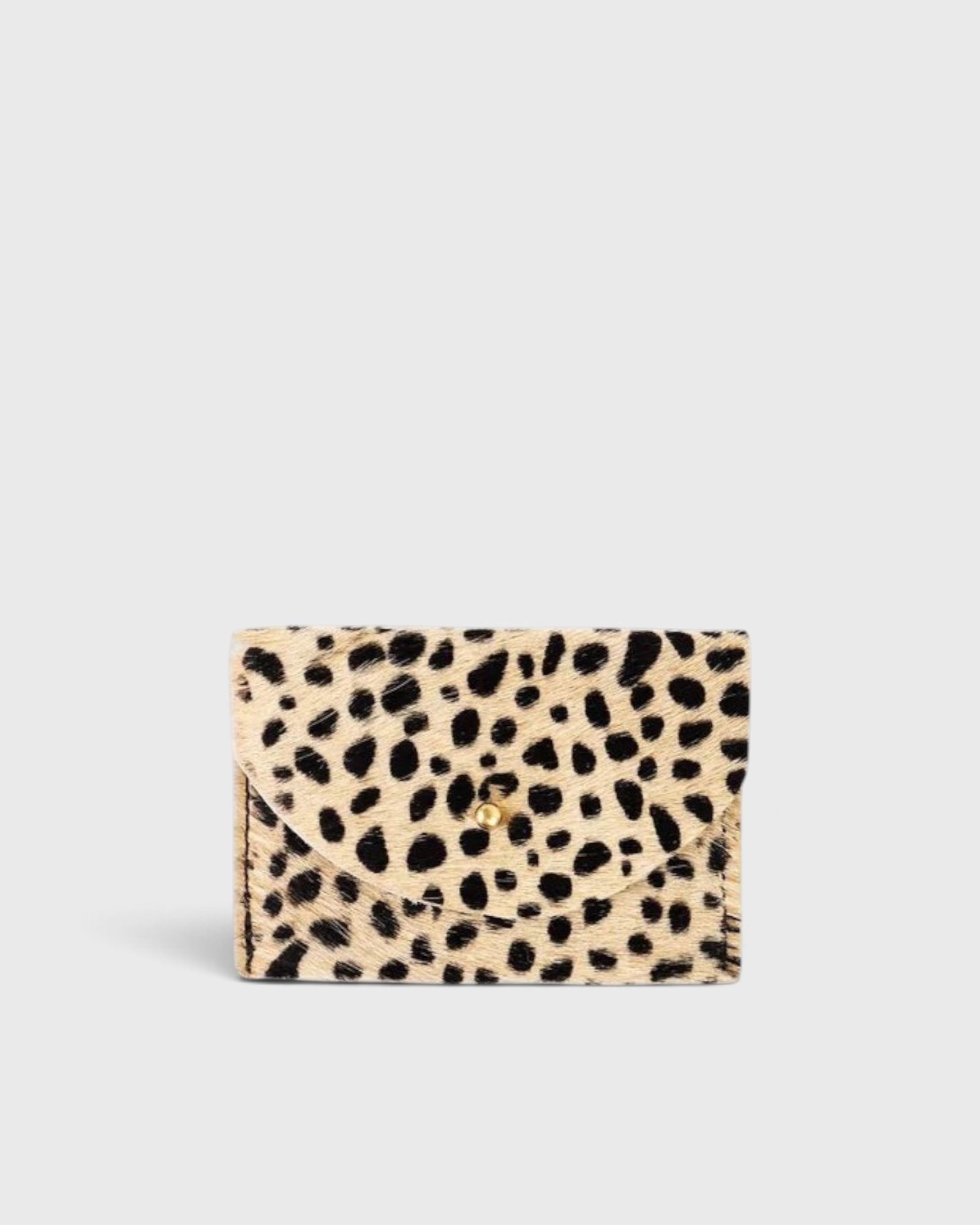 JONES + CO cardholder in beige and black spotted cowhide leather with a gold button closure.
