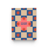 JONES + CO Squares and Bursts birthday card with blue and beige checkerboard pattern and red starburst illustrations.
