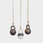JONES + CO stoneware jingle bells in round XS size with hand-painted rings on natural hemp rope hanging ornaments.
