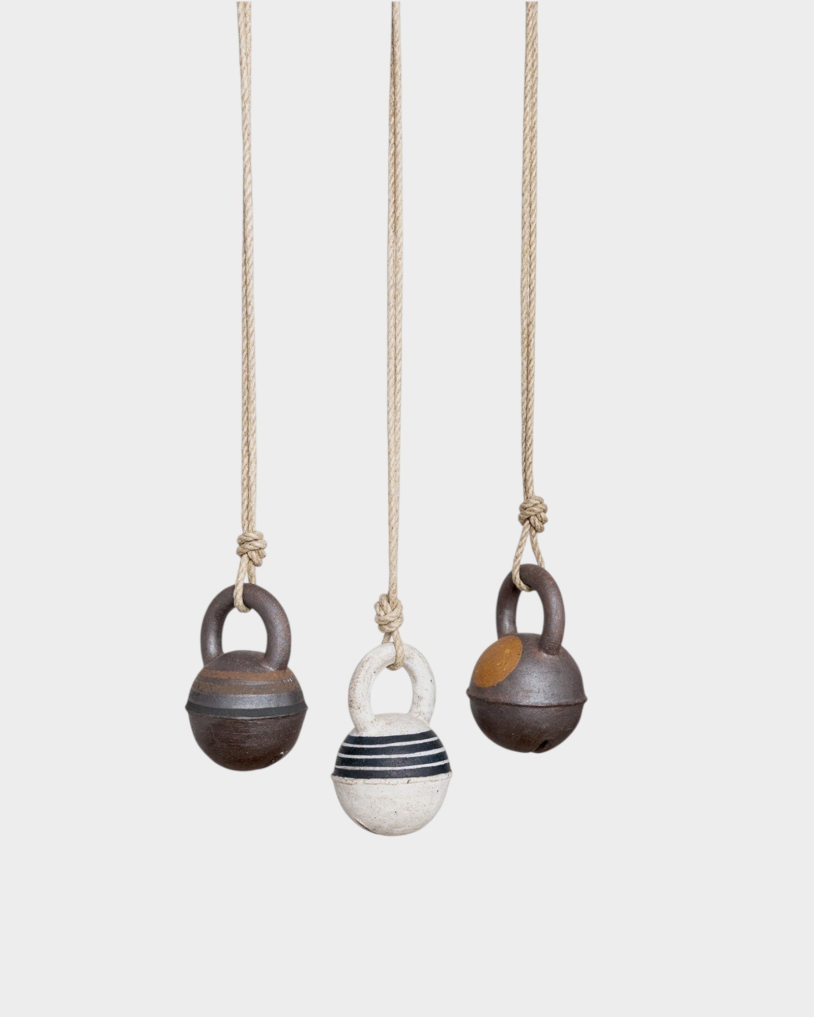 JONES + CO stoneware jingle bells in round XS size with hand-painted rings on natural hemp rope hanging ornaments.