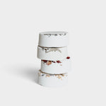 JONES + CO Sweet Dreams shower steamers stacked, white tablets with dried lavender and rose petals for relaxation.
