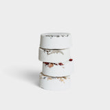 JONES + CO Sweet Dreams shower steamers stacked, white tablets with dried lavender and rose petals for relaxation.