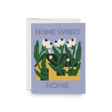 JONES + CO Sweet Home greeting card featuring a yellow house illustration with white flowers on a light purple background