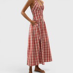 JONES + CO Del Rose midi dress in terra rosso check cotton with halterneck, front tie, and A-line skirt on a model.