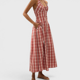 JONES + CO Del Rose midi dress in terra rosso check cotton with halterneck, front tie, and A-line skirt on a model.