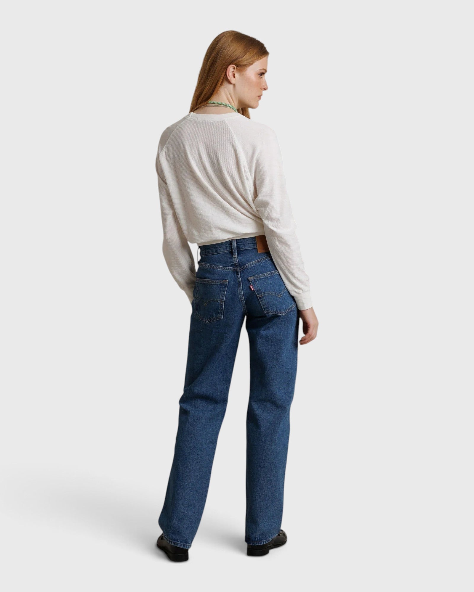 JONES + CO Jasper textured jersey crew neck sweater in natural worn with blue jeans by a woman, back view