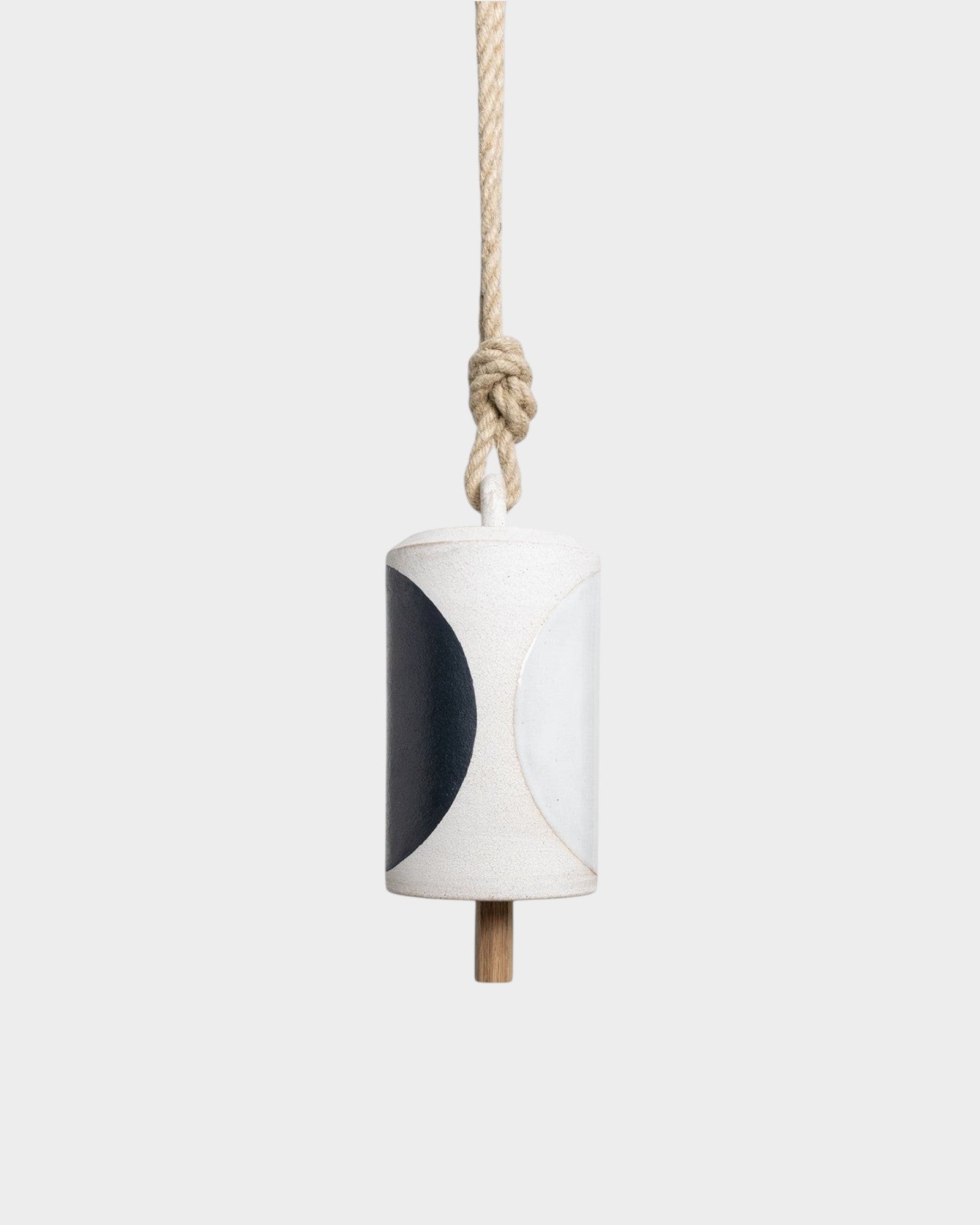 JONES + CO Thrown Bell in Domino Indigo featuring a cylindrical ceramic body with a bold black and white pattern.