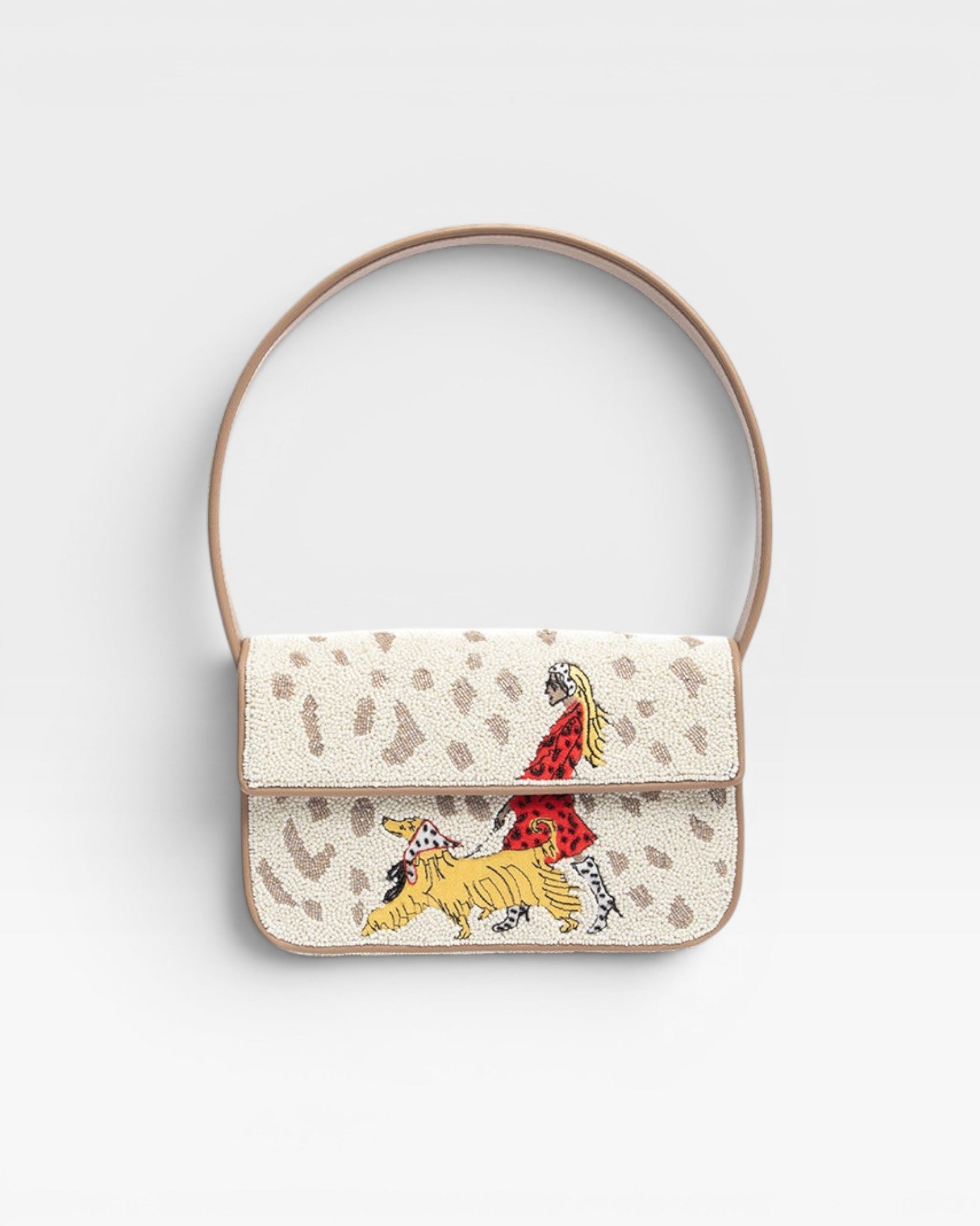 JONES + CO Tommy shoulder bag featuring hand-beaded dog walk design on cream background with vegan leather piping.