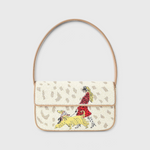 JONES + CO Tommy shoulder bag featuring hand-beaded dog walk design on cream background with vegan leather piping.