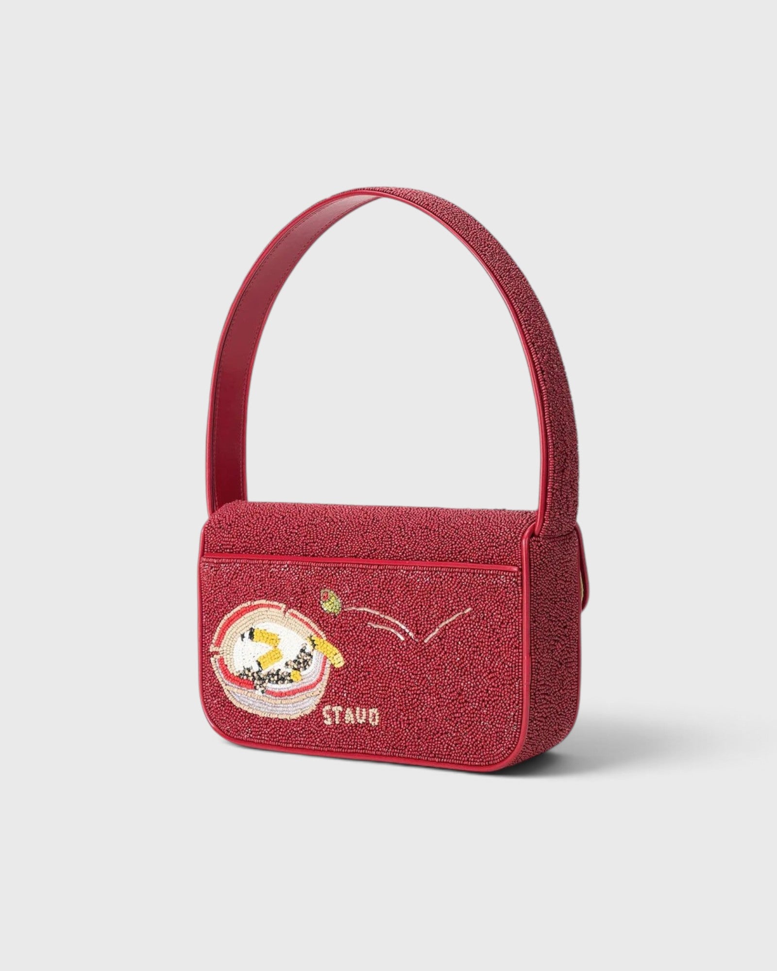 JONES + CO Tommy beaded shoulder bag in red with a playful martini glass graphic and vegan leather piping.