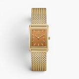 JONES + CO Virgil Small watch featuring a gold rectangular case, ochre dial, and woven mesh bracelet.