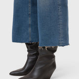 JONES + CO Wera mid blue denim jeans featuring a wide-leg cropped culotte silhouette with a raw frayed hem