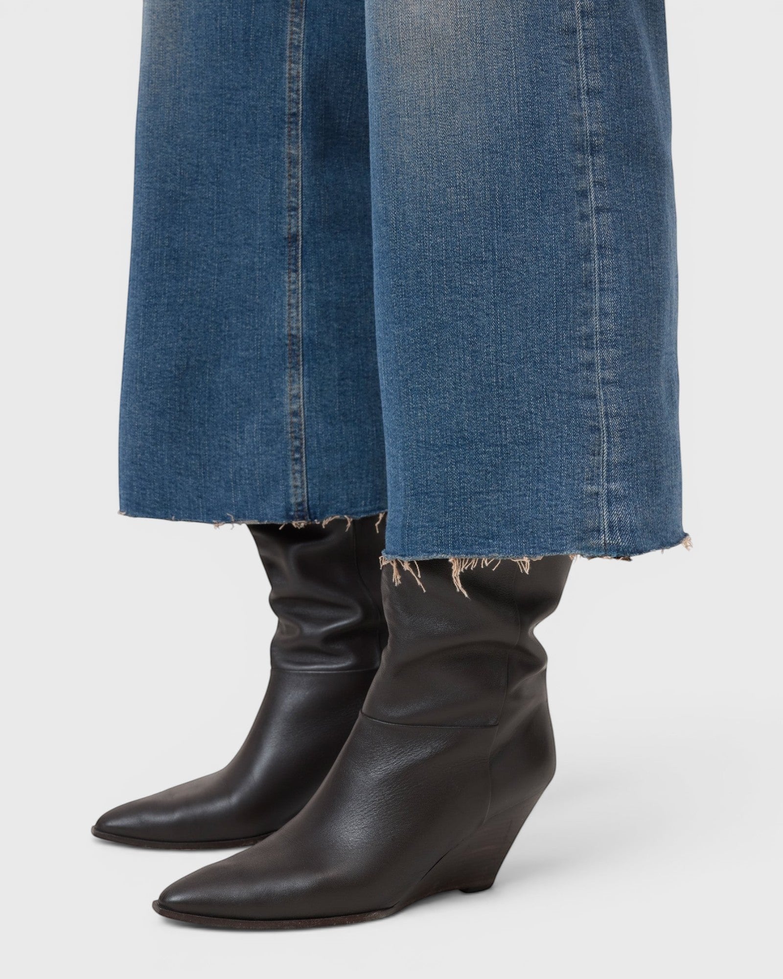 JONES + CO Wera mid blue denim jeans featuring a wide-leg cropped culotte silhouette with a raw frayed hem