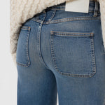JONES + CO Wera mid blue denim jeans featuring iconic X-pockets and a high-waisted wide-leg silhouette.
