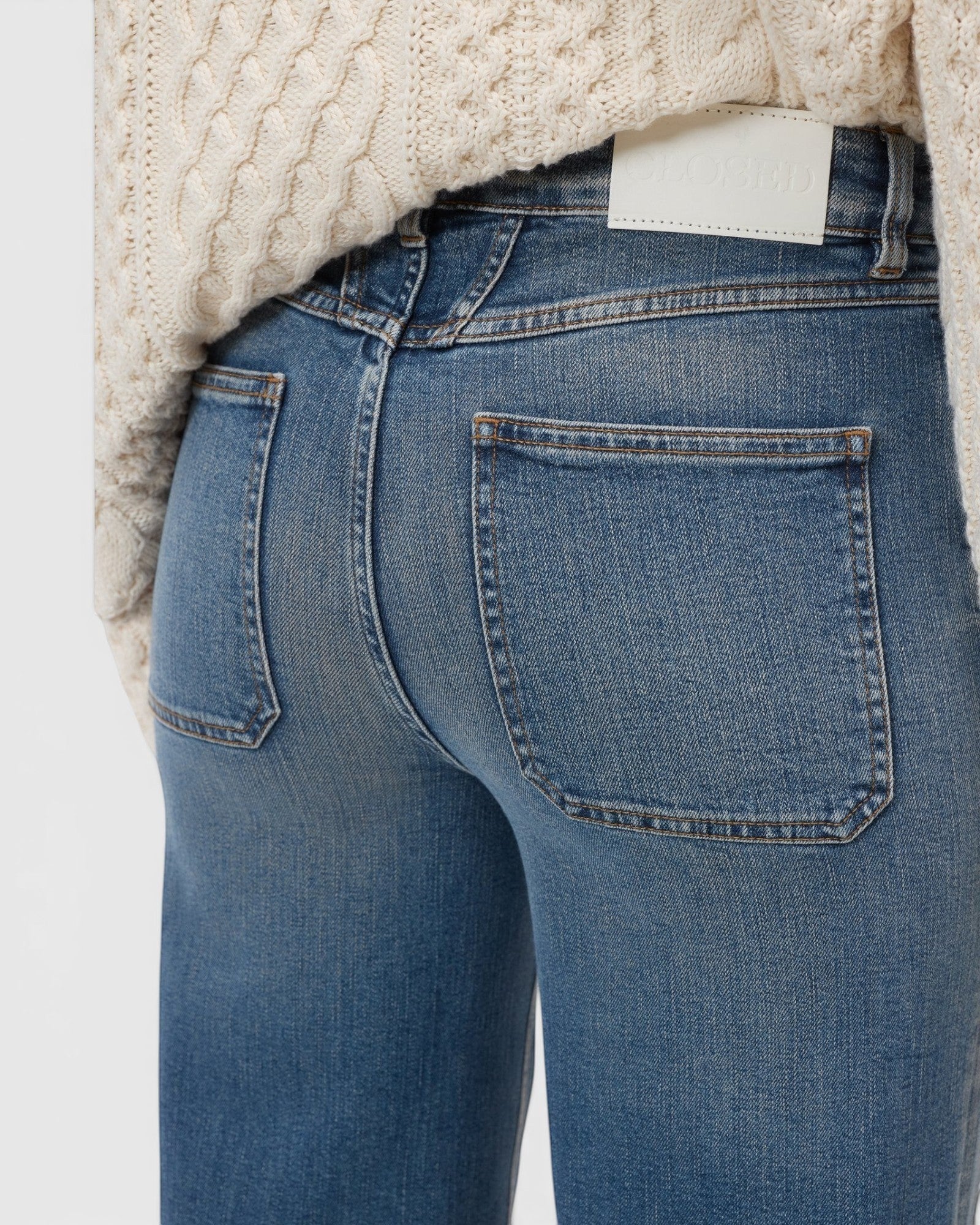 JONES + CO Wera mid blue denim jeans featuring iconic X-pockets and a high-waisted wide-leg silhouette.