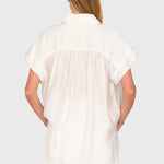 Back view of JONES + CO white Trinity button top in lightweight brushed cotton with a relaxed boxy silhouette.