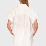 Back view of JONES + CO white Trinity button top in lightweight brushed cotton with a relaxed boxy silhouette.