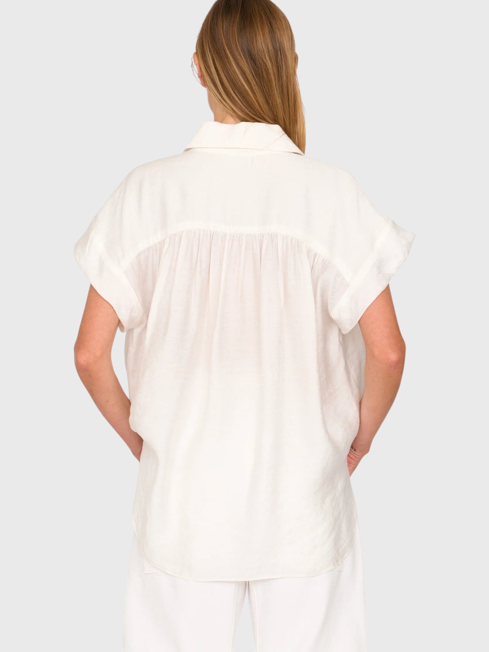 Back view of JONES + CO white Trinity button top in lightweight brushed cotton with a relaxed boxy silhouette.