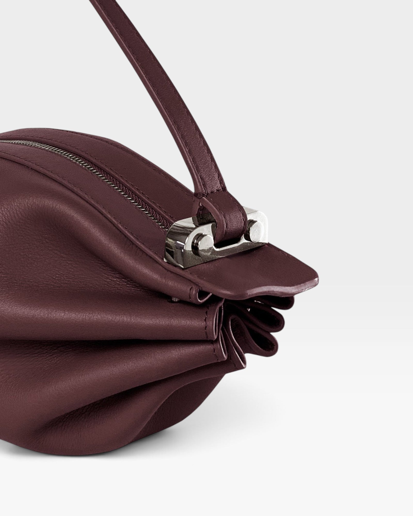 JONES + CO Bon-Bon wine-colored calf leather handbag featuring a pleated design and polished palladium brass clasp.