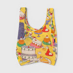 JONES + CO Baggu reusable grocery bag in yellow ripstop nylon featuring a colorful patisserie cake print