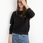 Model wearing a JONES + CO Ziggy sweatshirt in vintage black with a textured fleece finish and ribbed cuffs.