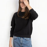 Model wearing a JONES + CO Ziggy sweatshirt in vintage black with a textured fleece finish and ribbed cuffs.