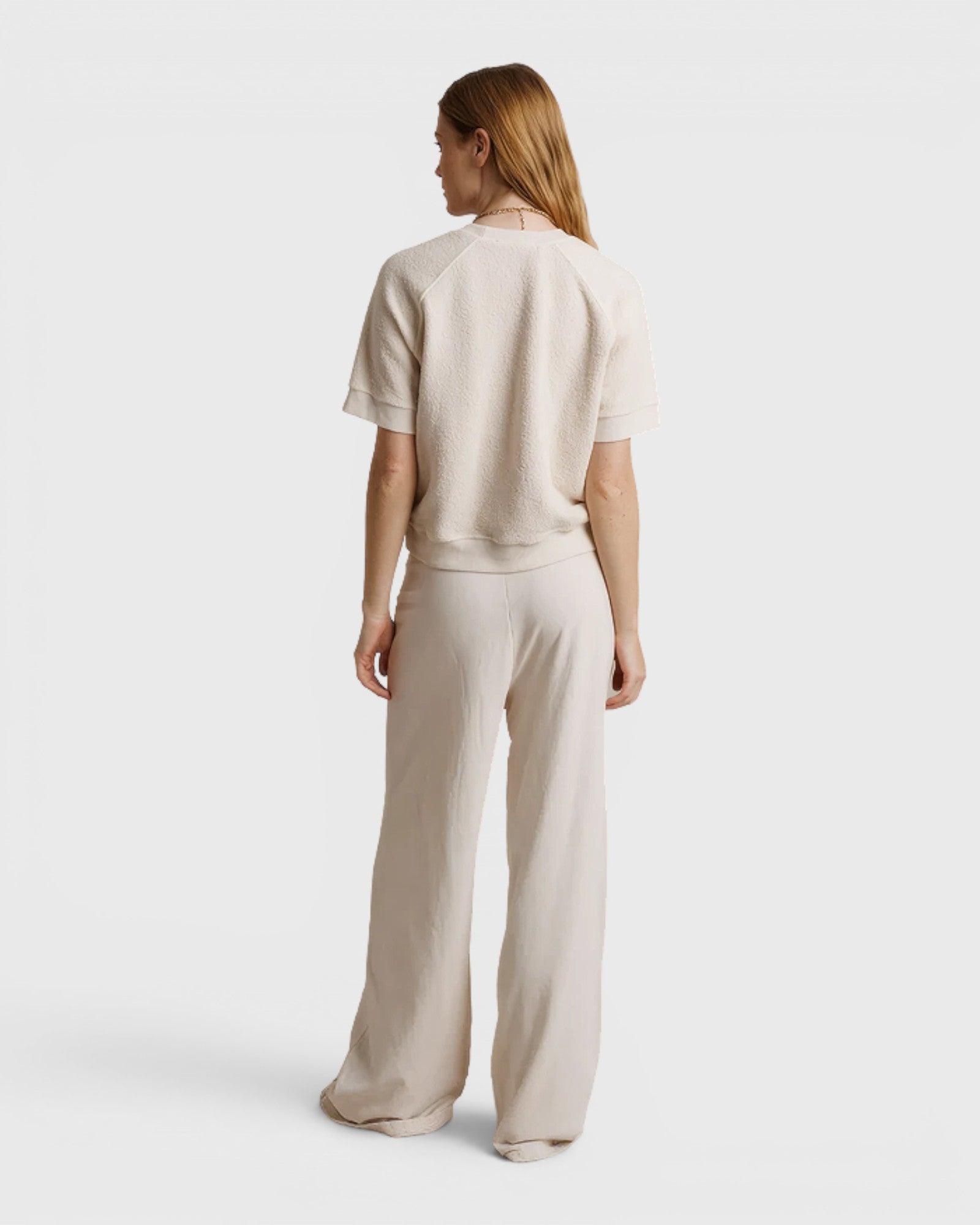 JONES + CO Ziggy short sleeve sweatshirt in sugar cream with raglan sleeves, worn with matching wide-leg trousers
