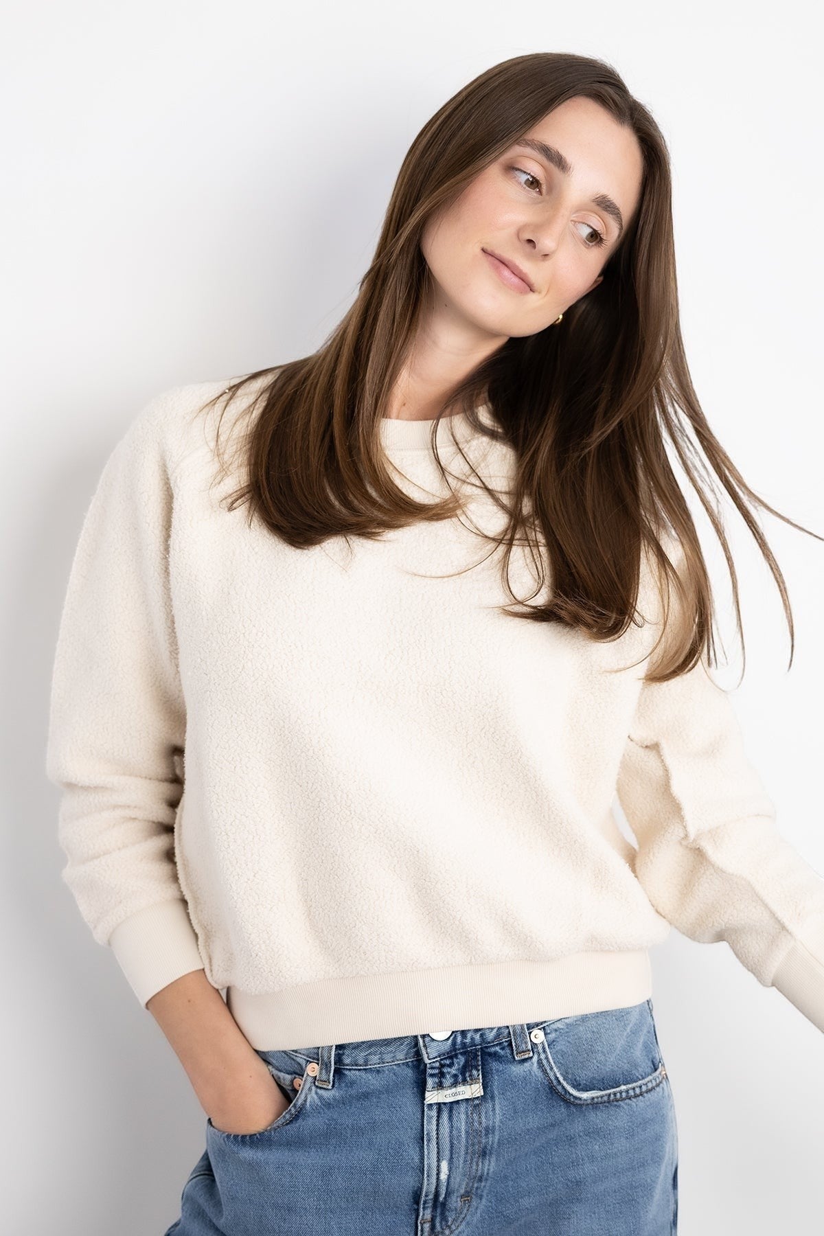 JONES + CO Ziggy sweatshirt in sugar cream textured fleece with a crew neck and cropped sleeves worn with blue jeans