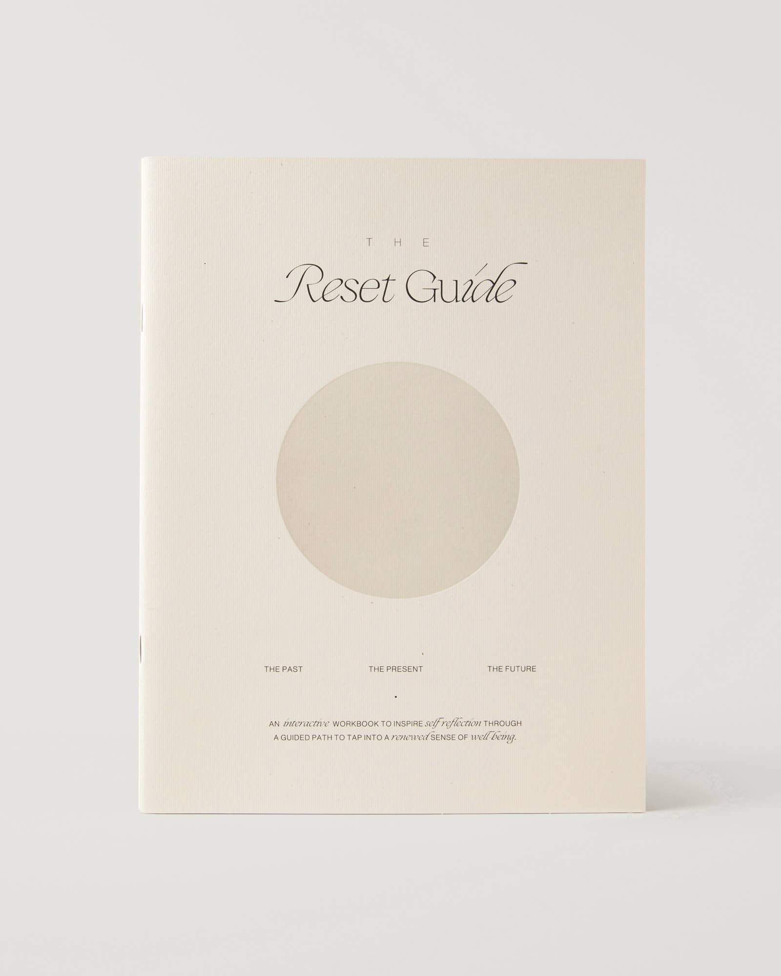 Book titled 'The Reset Guide' with a circular design on a white background
