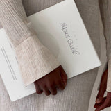 Person holding a book titled 'Reset Guide' with a neutral background