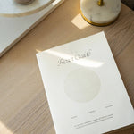 White book titled 'Reset Guide' on a wooden surface with soft shadows
