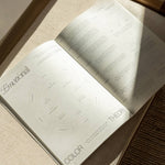 Open book on a textured surface with 'Emotional Color Theory' visible