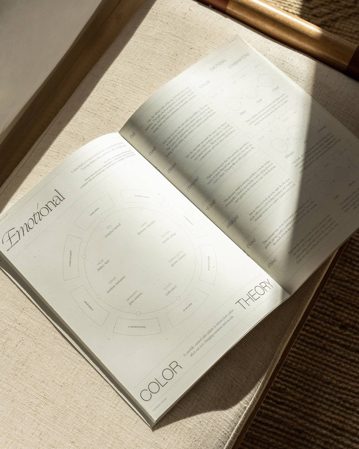 Open book on a textured surface with 'Emotional Color Theory' visible