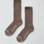 Pair of brown socks with white trim on a light gray background