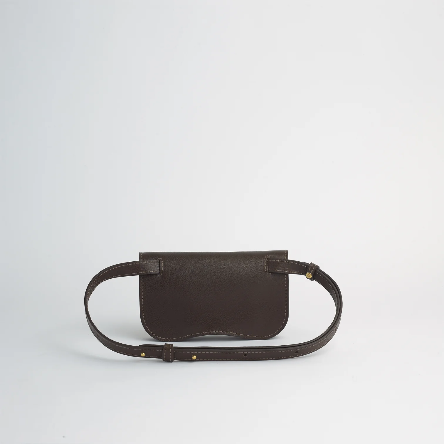 Brown leather belt bag on a light gray background
