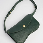 Green leather bag with a gold clasp on a light gray background