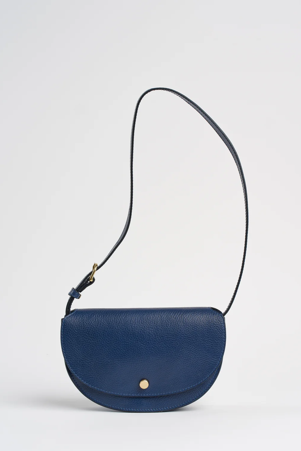 Blue leather crossbody bag on a light gray background