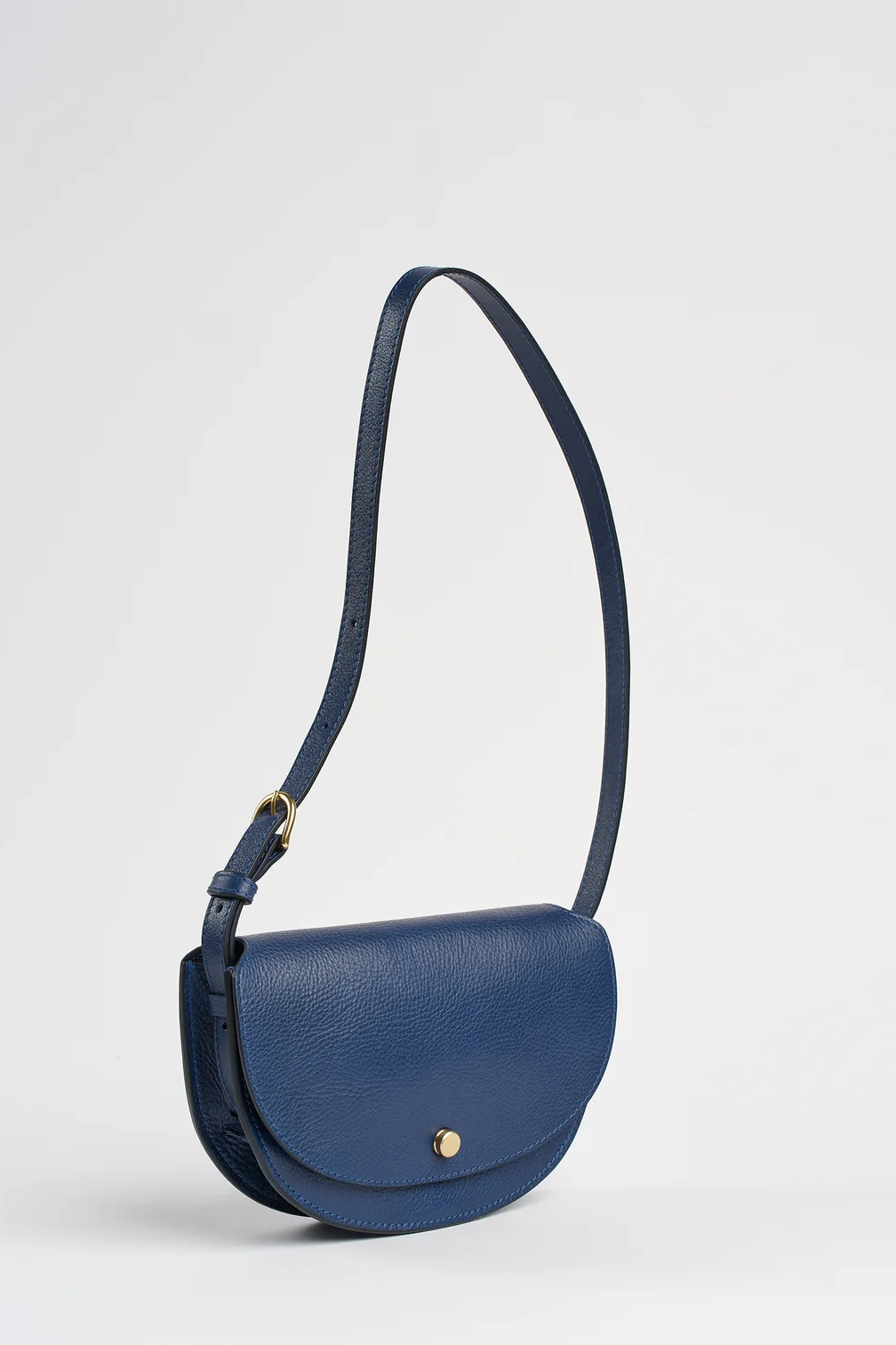 Blue handbag with a strap on a light gray background