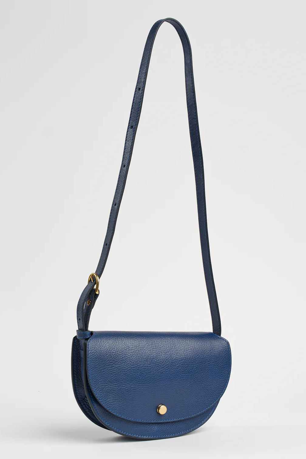 Blue handbag with a strap on a light gray background