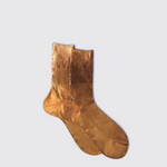 Pair of gold socks on a light gray background